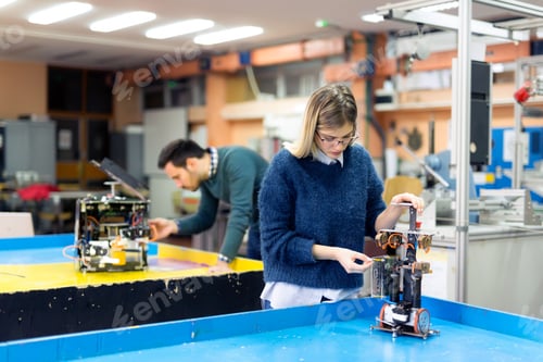 Aperçu: Young woman engineer working on robotics project