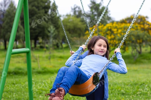 Preview: girl-playing-on-the-swing-at-the-park