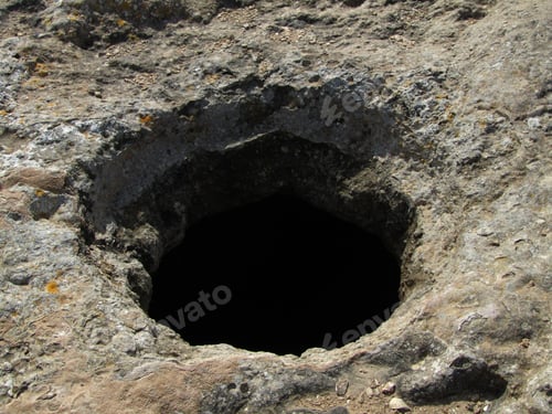 Preview: Closeup shot of a hole dug through the ground from the Bronze Age in Maltese Islands, Malta