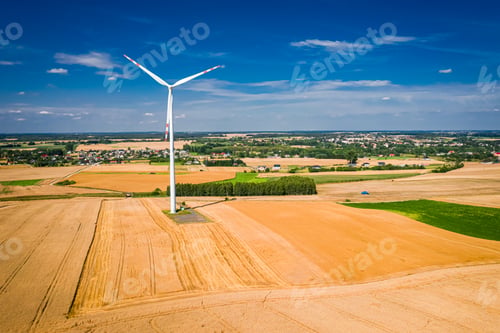 Preview: Wind turbines on the field and combine during harvest