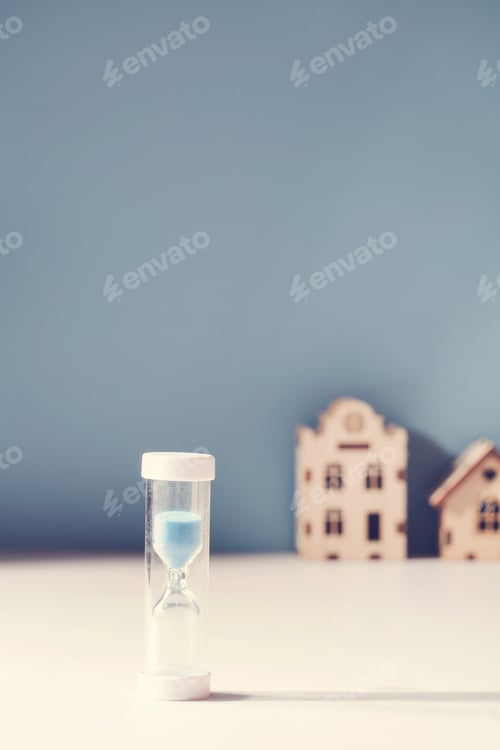 Preview: housing mortgage, property market , demand for real estate concept. hourglass and small toy houses