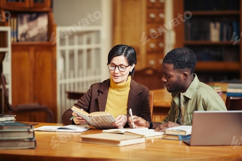 Preview: Two People Reading in Library