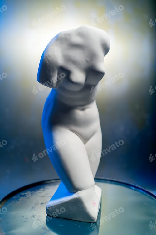 Preview: close-up white sculpture in the form of a body standing on a barrel museum exhibit performance art