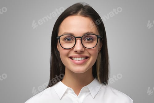 Preview: Young business woman in glasses, looking at camera with positive confident smile, feeling competent