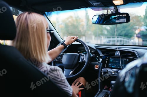 Preview: Woman in sunglasses driving a car