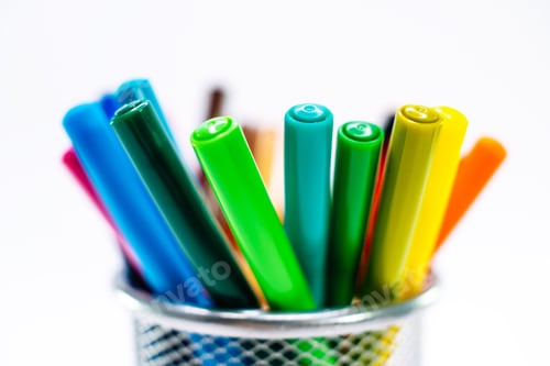 Preview: Colored pencils, pens and markers in a clerical case on white background