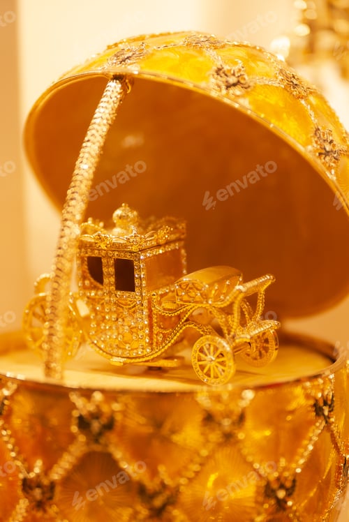 Preview: A golden car in a golden egg-shaped box.