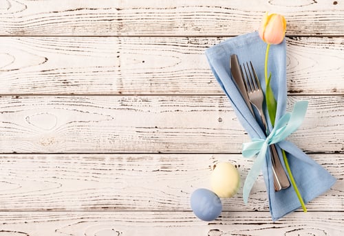 Preview: Easter eggs, tulips and cutlery top view flat lay on white rustic background