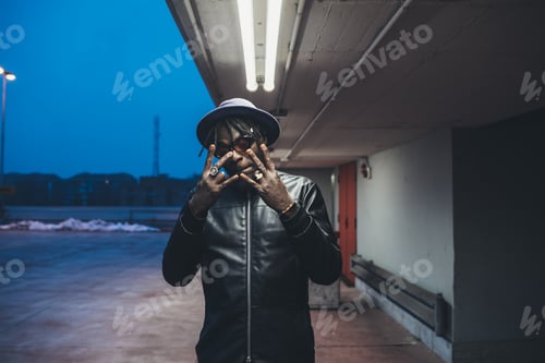 Preview: young african bearded man outdoors posing looking camera
