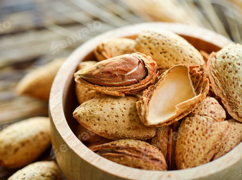 Preview: Almonds in a bowl on wooden background