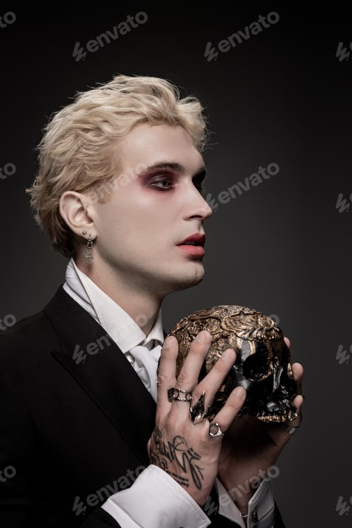 Preview: Young man in striking Halloween costume exudes charisma and mystery at nighttime gathering