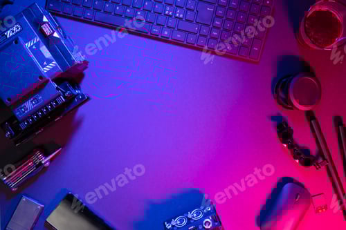 Preview: Overhead view of computer parts with coffee and video camera on illuminated table