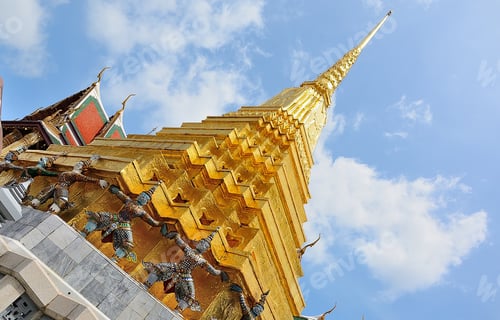 Preview: Golden chedi rising above ornate figures in grand palace, bangkok, thailand