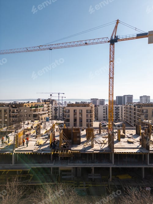 Preview: Aerial view of a cityscape with ongoing construction projects and completed residential buildings