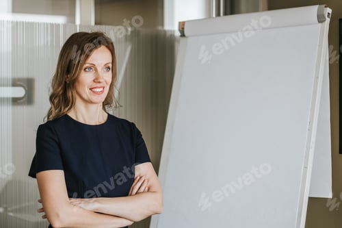 Preview: Professional Woman Standing Confidently Next to Whiteboard in Office