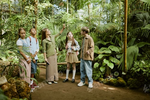 Preview: Female Tour Guide Working with Group of Teenagers in Botanical Garden