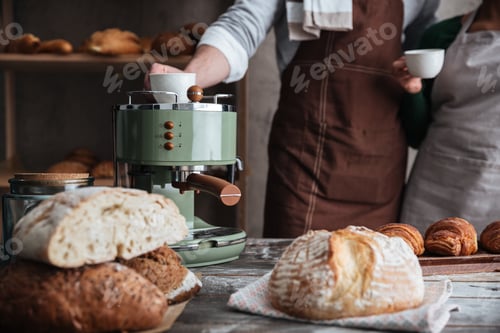 Preview: Loving couple bakers drinking coffee.