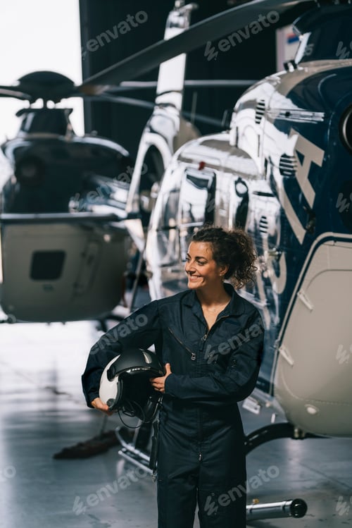Preview: Pilot girl poses with her helicopter.