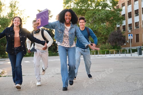 Preview: Diverse students running happily on university campus street