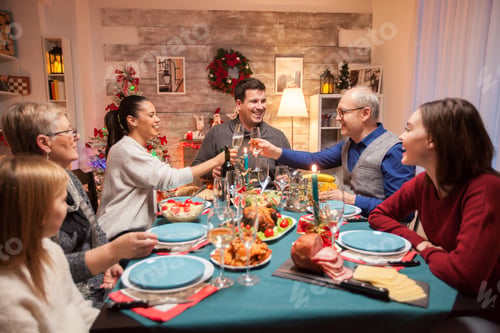 Preview: Happy senior man clinking a glass of wine
