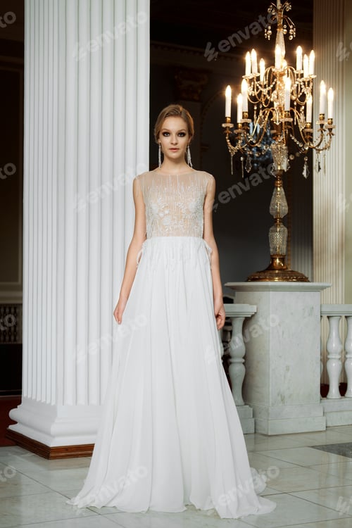 Preview: Elegant Woman in White Gown Posing Indoors
