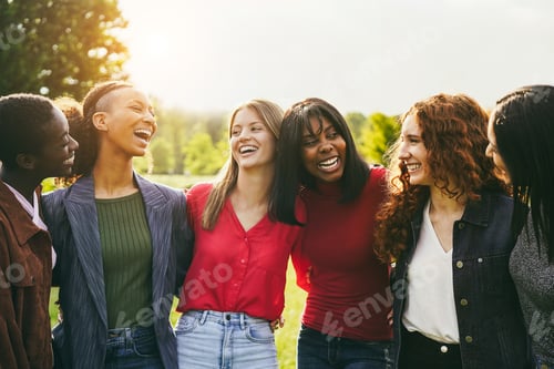 Preview: Multiracial female friends having fun hugging together outdoor - Focus on center african girl face