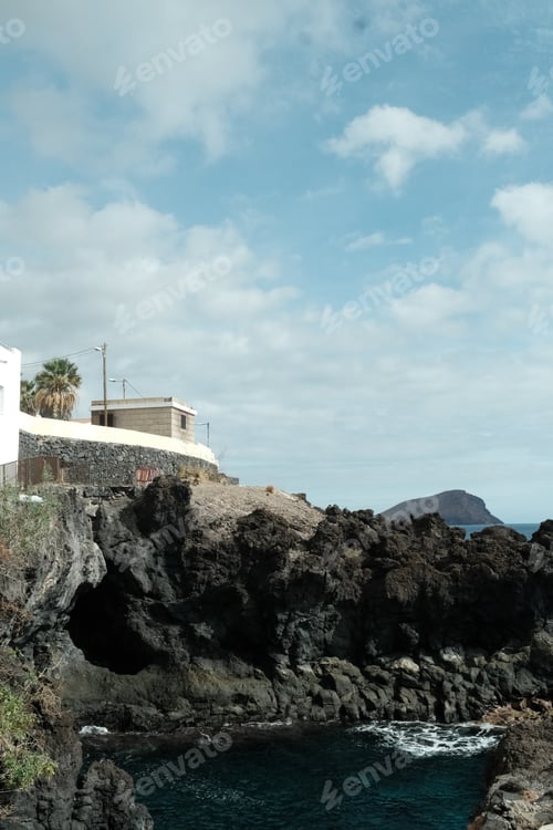 Preview: Majestic lighthouse perched atop a rocky cliff overlooking the vast expanse of the ocean