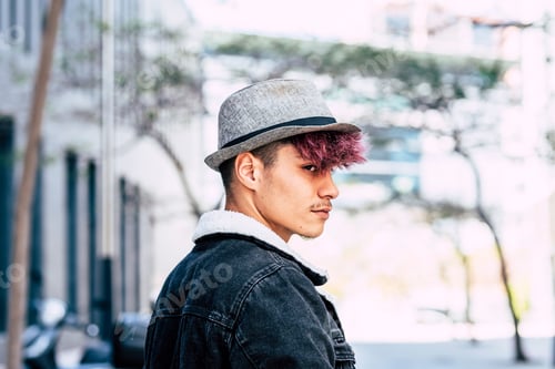 Preview: Portrait of alternative diversity teenager look style with young boy with violet hair and hat