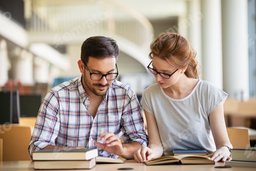 Preview: Happy group of success students studying and working together in a college library