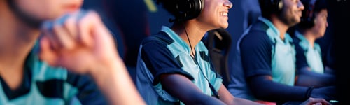 Preview: Young woman with headphones plays computer game in internet club