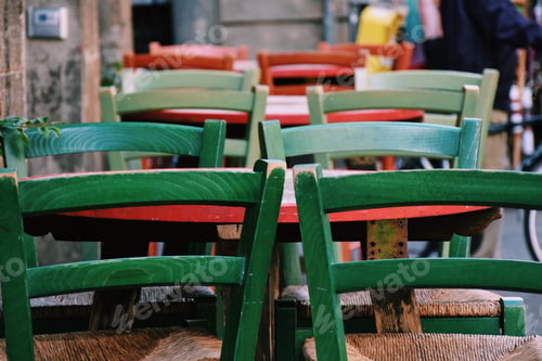 Preview: Bright and colorful empty wooden chairs at an outdoor restaurant or cafe
