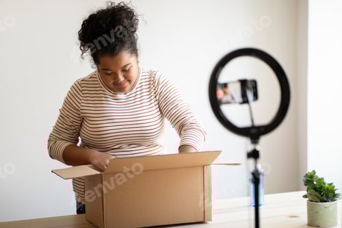 Preview: Famous blogger chubby hispanic woman unpacking parcel and streaming