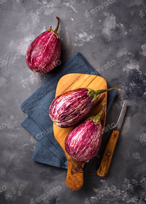Preview: Fresh striped purple aubergines on grey background