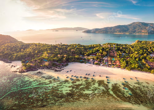 Preview: Beautiful Koh lipe island with tropical sea, fishing boat and resort on the beach at the sunset