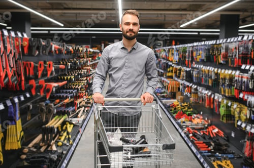 Preview: Portrait of happy mature man standing in hardware store
