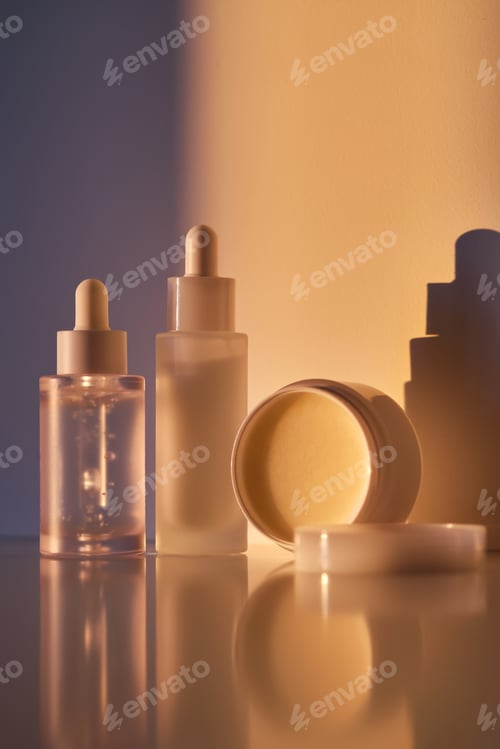 Preview: Cosmetic products for skin care in the rays of the setting sun.