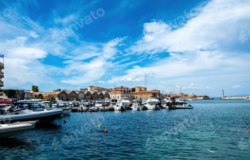 Preview: Venetian harbour in Old Town of Chania Crete Greece. Moored boat at marina, beacon, sea, blue sky.