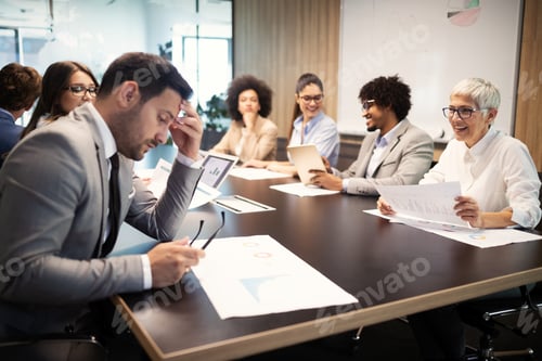 Preview: Successful group of business people at work in office