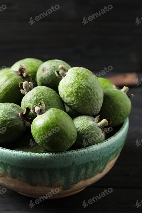 Preview: Fresh green feijoa fruits on black wooden table, closeup