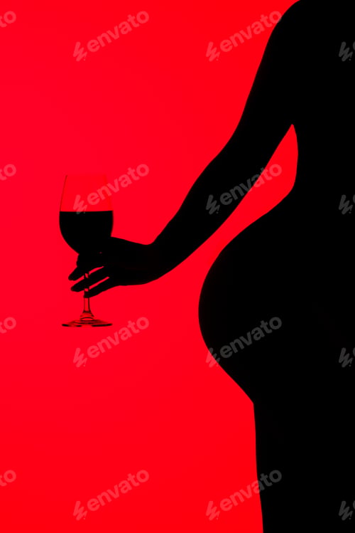Preview: cropped view of black silhouette of sensual girl holding glass of wine isolated on red
