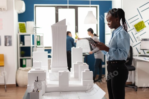 Preview: African american architect woman working on tablet