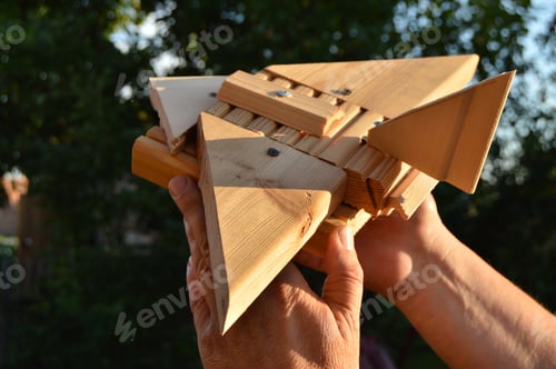 Preview: Homemade wooden toy airplane in the hands of men, the concept of journey, dreams, freedom, playing