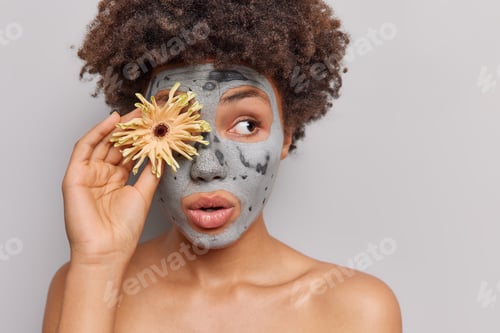 Preview: Woman with Facial Mask Holding a Flower