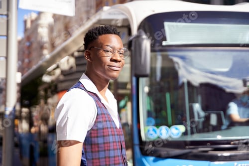 Preview: portrait of an African-American man in the city waiting for a bus.
