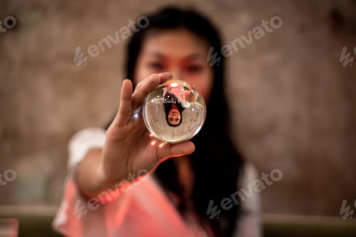 Preview: Asian woman showing a crystal sphere