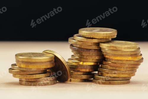 Preview: Stacks of Coins on a Light Brown Surface