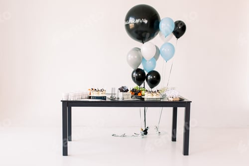 Preview: Delicious birthday reception. Birthday Cake, fruits and desserts on a background balloons party