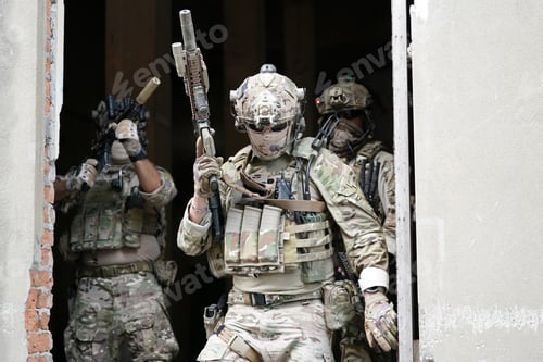 Preview: Soldier in full US MARSOC armed with assault rifle run through the abandoned building. Military