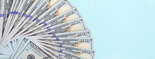 Preview: Fan of a US dollar bills of a new design lies on a light blue background.