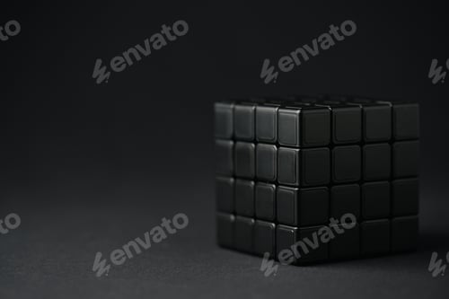 Preview: KYIV, UKRAINE - FEBRUARY 21, 2020: selective focus of dark rubik cube on black with copy space